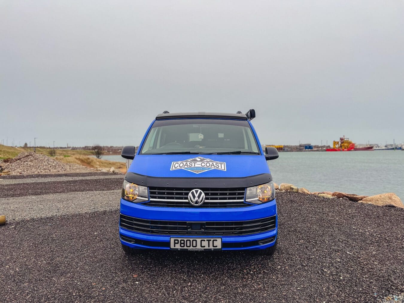 Home 19 Front view of blue VW T6 Coast to Coast campervan at Peterhead harbour, Scotland – available for motorhome and campervan hire