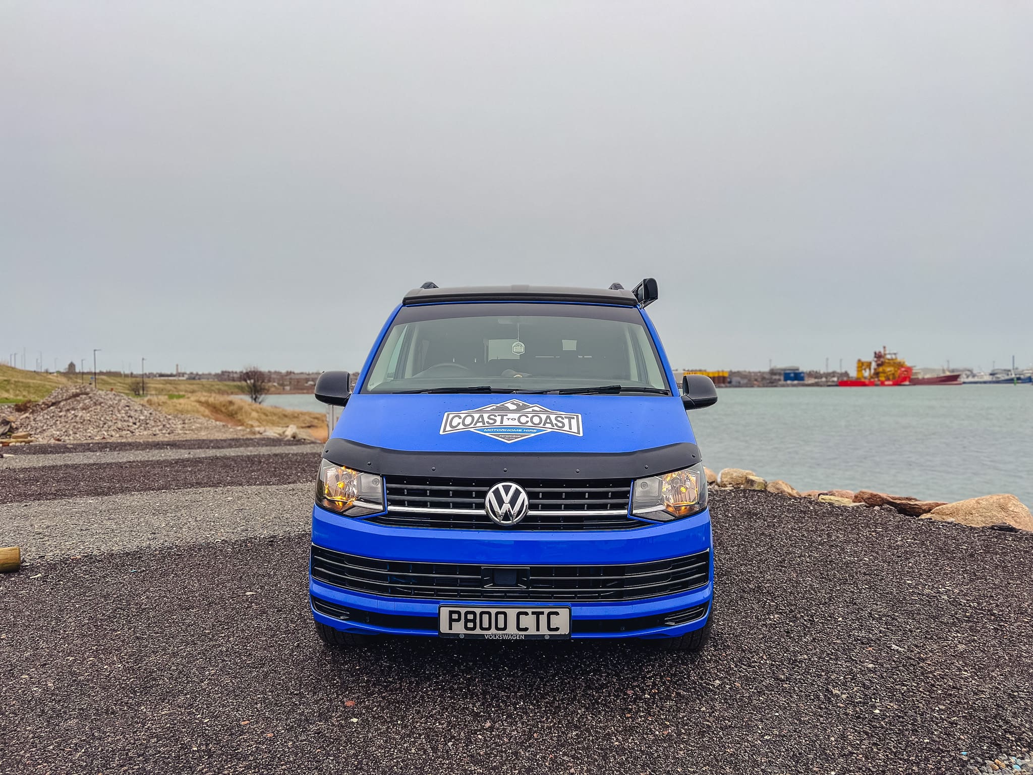 Front view of blue VW T6 Coast to Coast campervan at Peterhead harbour, Scotland – available for motorhome and campervan hire