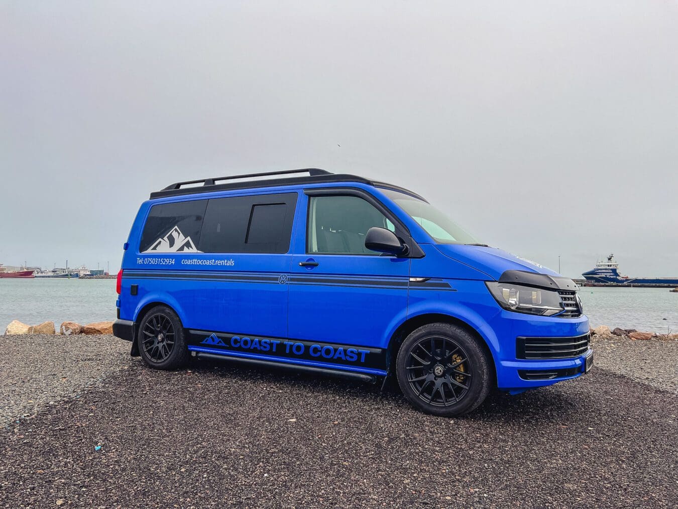 Home 23 Blue VW T6 Coast to Coast campervan parked at Peterhead harbour in Scotland – available for hire from Coast to Coast motorhome rentals