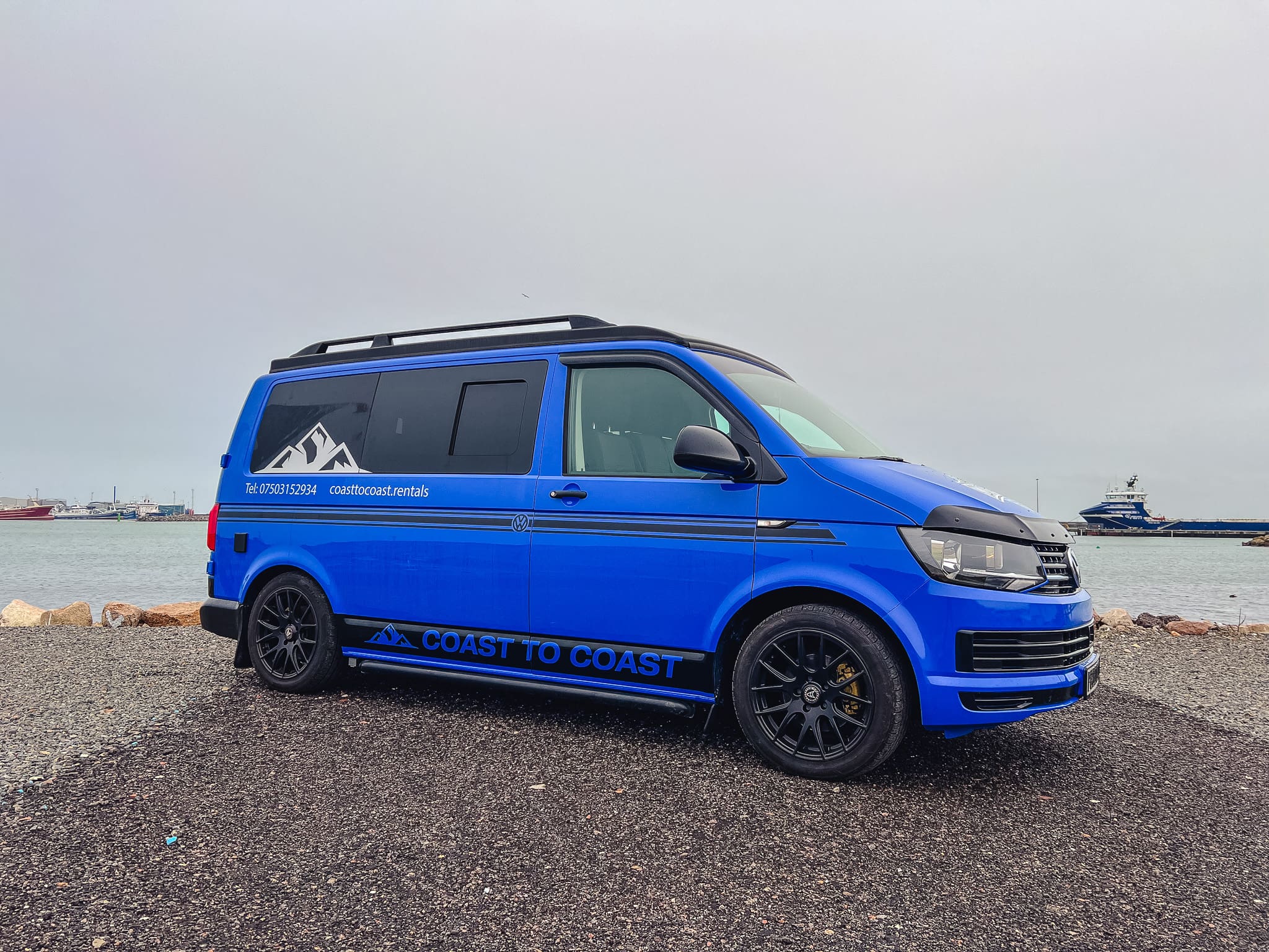 Blue VW T6 Coast to Coast campervan parked at Peterhead harbour in Scotland – available for hire from Coast to Coast motorhome rentals