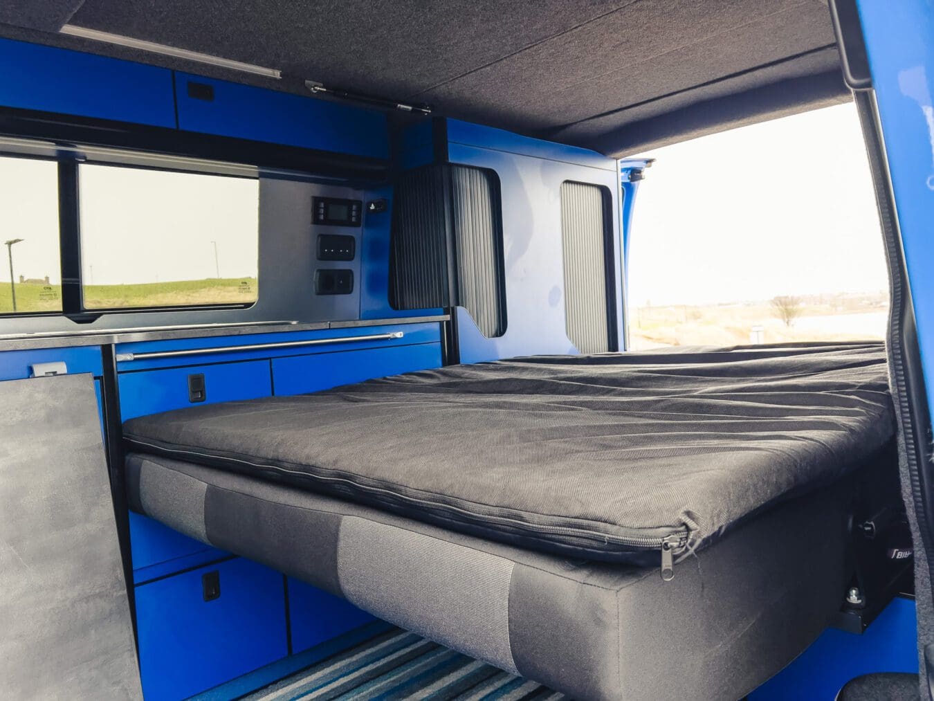 Home 27 Interior of VW Coast to Coast campervan with fold-out bed setup, available for hire in Peterhead, Scotland